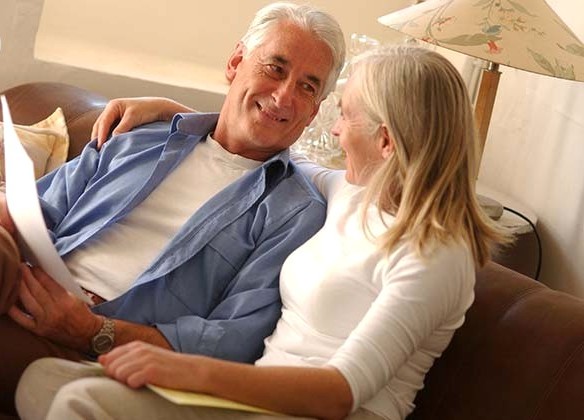 60 years old couple conversing together.